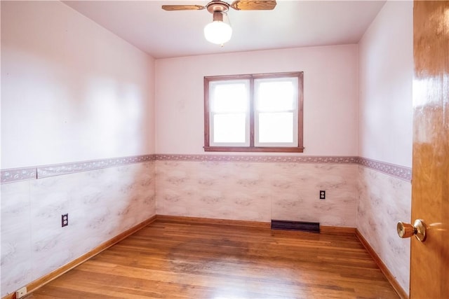 empty room featuring wood-type flooring and ceiling fan