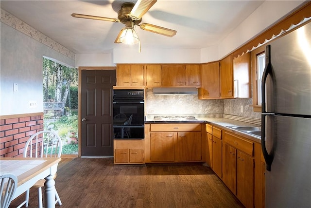 kitchen featuring ceiling fan, dark wood-type flooring, stainless steel appliances, and sink