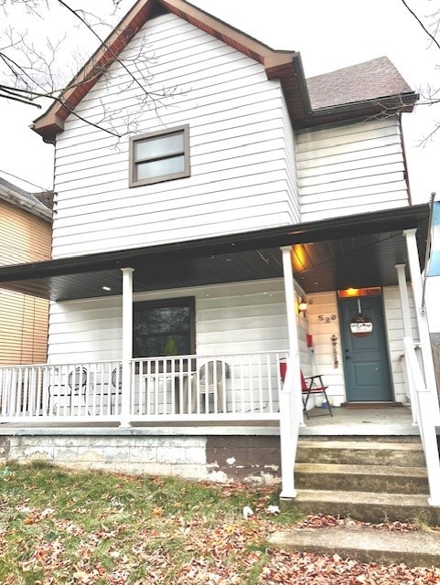 rear view of house featuring covered porch