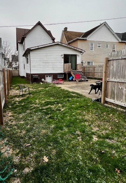 back of property featuring a yard and a patio