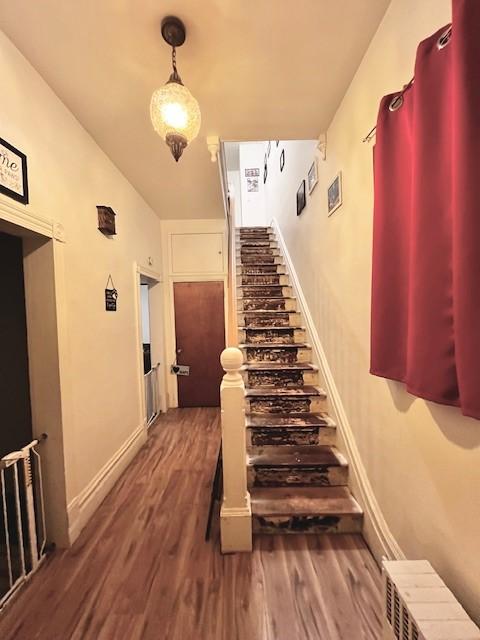 stairway featuring hardwood / wood-style floors