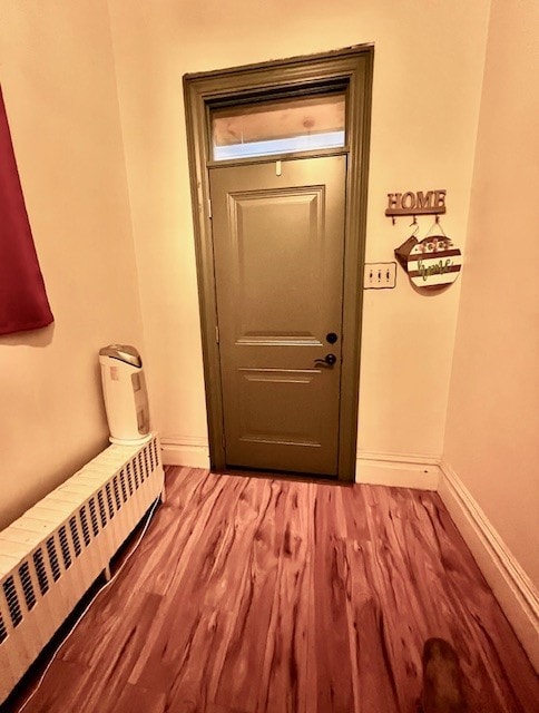 entryway with radiator and light hardwood / wood-style floors