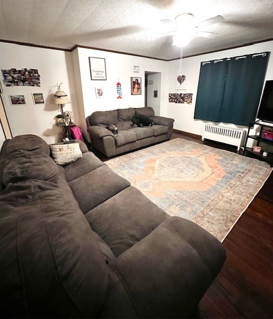 living room featuring radiator, a textured ceiling, hardwood / wood-style flooring, and ceiling fan