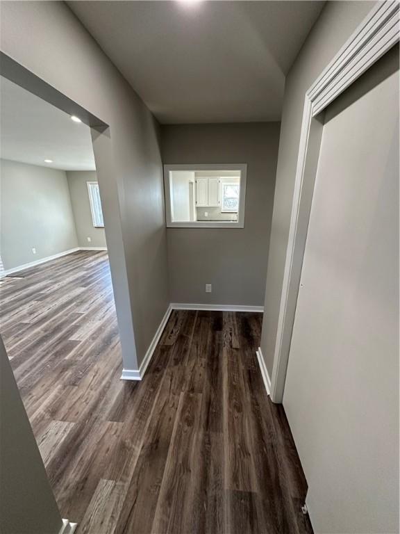 hallway with dark wood-type flooring