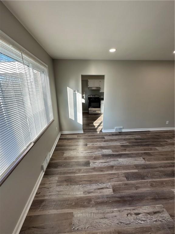 empty room featuring dark hardwood / wood-style flooring