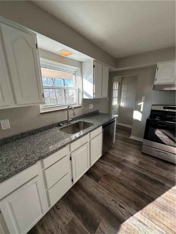 kitchen featuring sink, white cabinetry, dark hardwood / wood-style floors, and stainless steel appliances