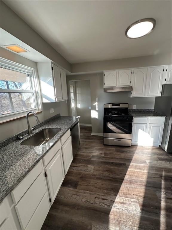 kitchen with stainless steel appliances, dark hardwood / wood-style flooring, white cabinetry, and sink