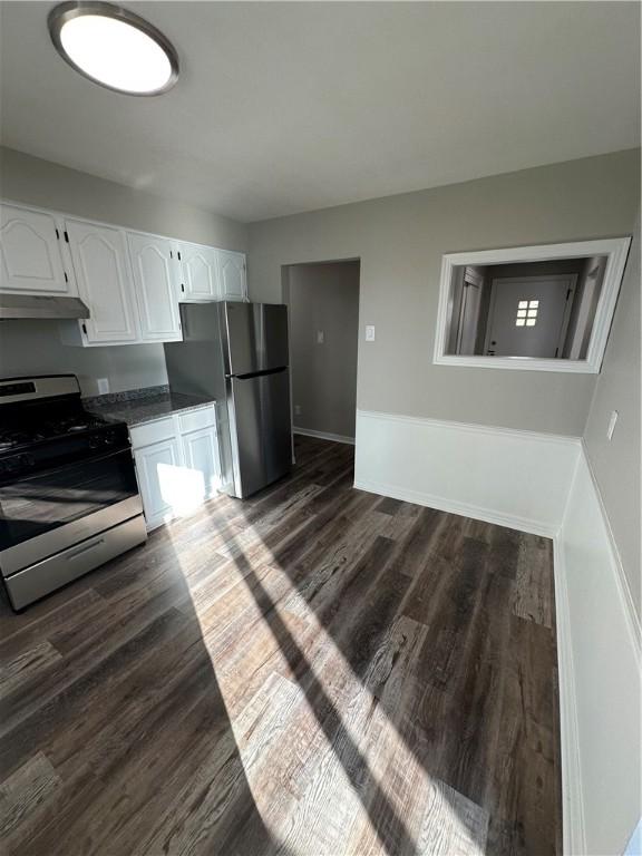 kitchen featuring dark wood-type flooring, stainless steel appliances, and white cabinetry