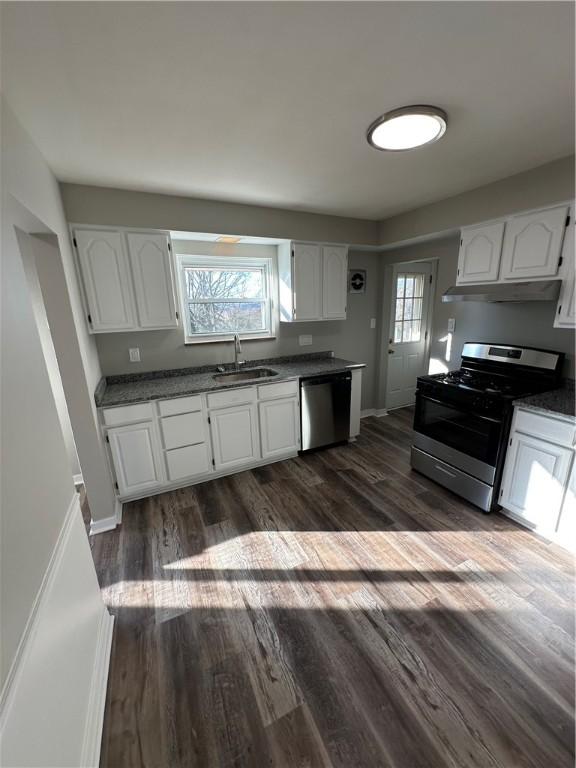 kitchen featuring dark wood-type flooring, sink, white cabinets, and stainless steel appliances