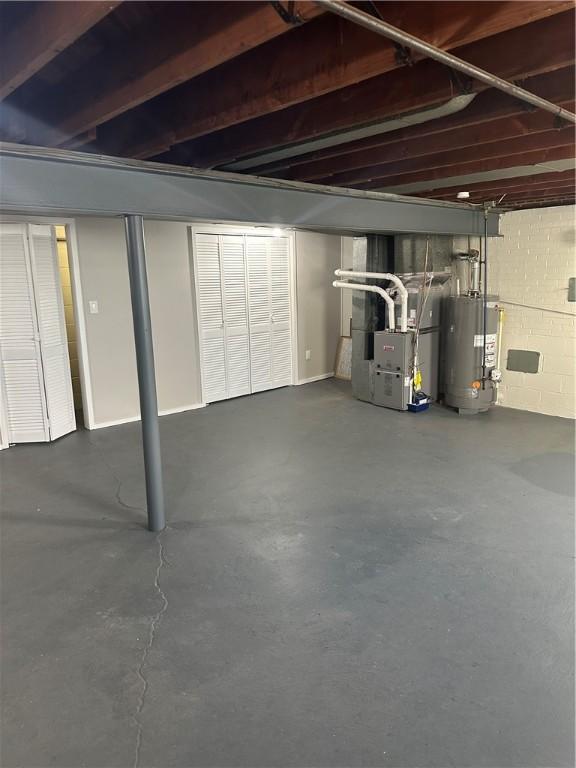 basement featuring heating unit and gas water heater