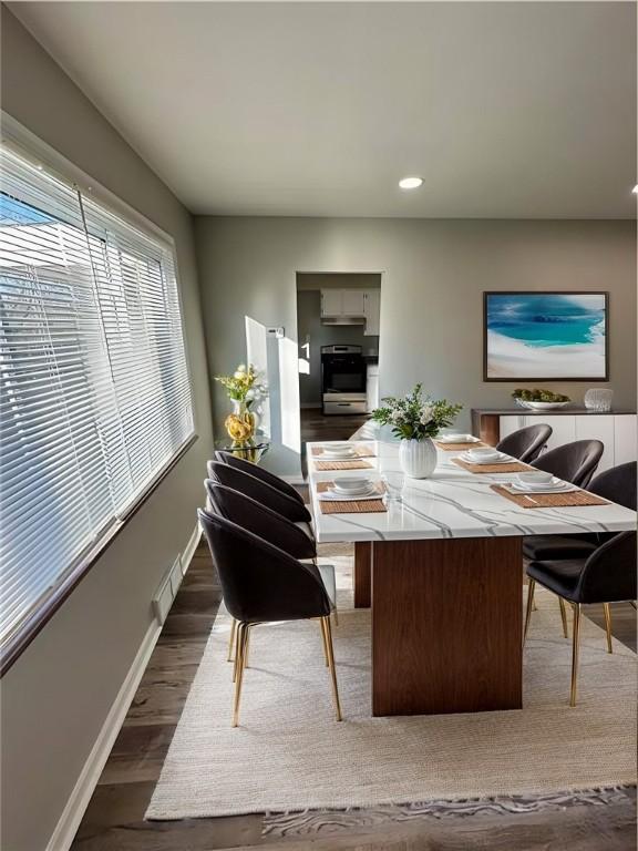 dining space with dark wood-type flooring