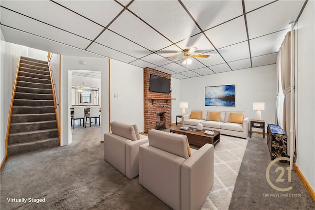 carpeted living room featuring ceiling fan and a fireplace