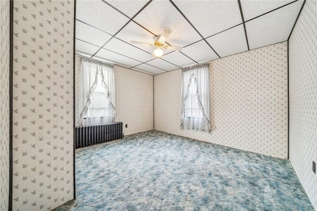 bonus room featuring carpet flooring, ceiling fan, a healthy amount of sunlight, and radiator heating unit