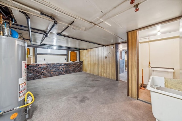 basement with carpet flooring and gas water heater