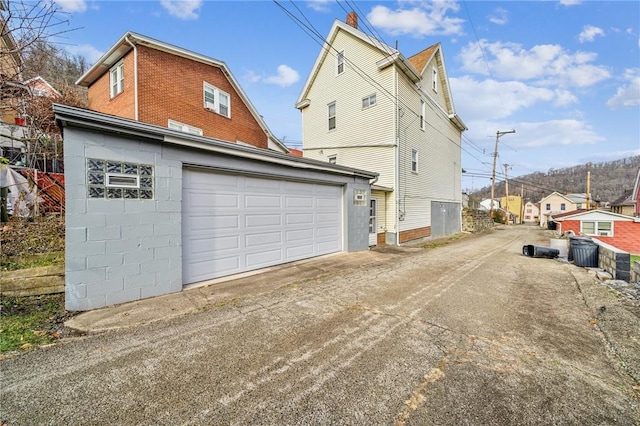 view of home's exterior with a garage and an outdoor structure