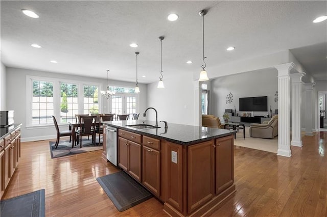 kitchen featuring sink, pendant lighting, a center island with sink, dishwasher, and dark hardwood / wood-style floors