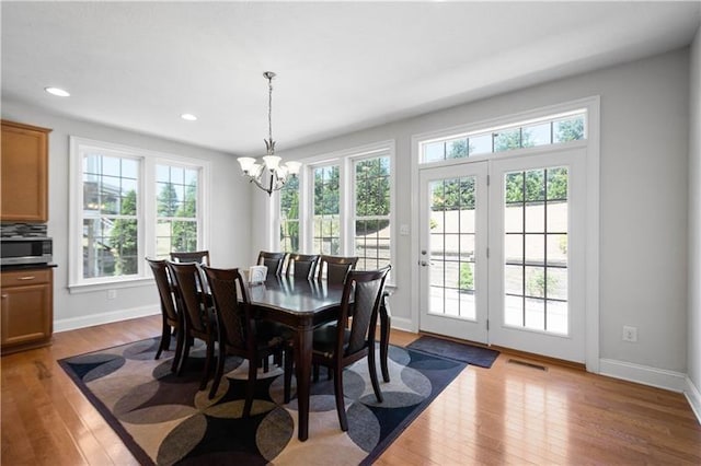 dining area with a chandelier and dark hardwood / wood-style flooring