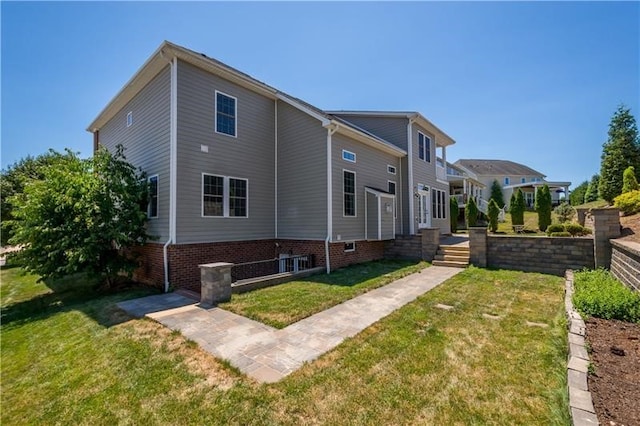 back of house with a lawn