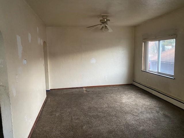 carpeted empty room featuring ceiling fan and baseboard heating