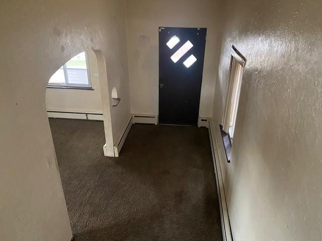 entrance foyer with dark carpet and baseboard heating