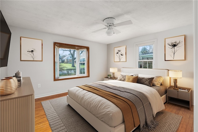 bedroom with light hardwood / wood-style flooring and ceiling fan