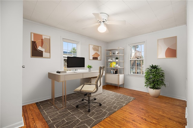 home office with ceiling fan, ornamental molding, dark wood-type flooring, and a wealth of natural light