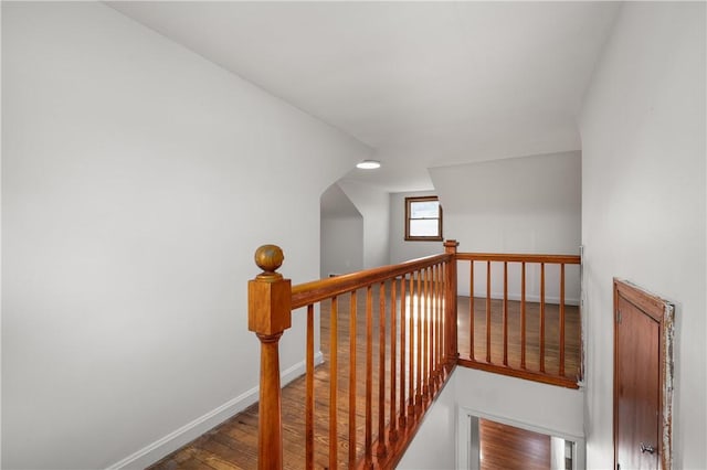 stairs featuring hardwood / wood-style floors