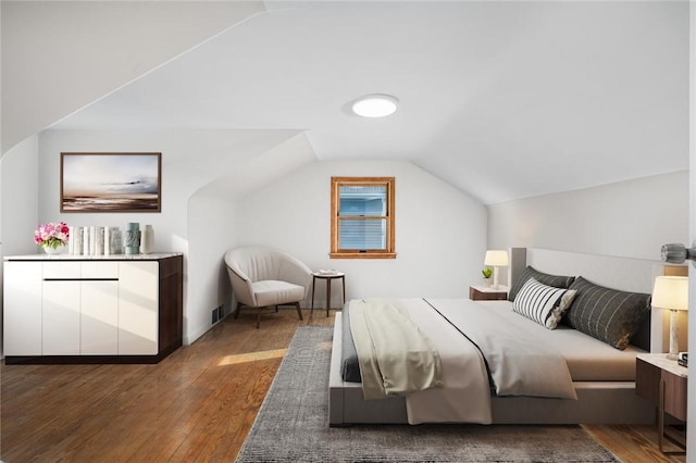 bedroom featuring dark hardwood / wood-style floors and vaulted ceiling