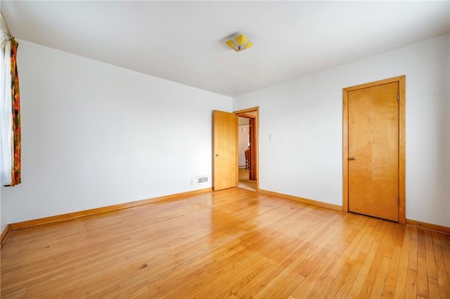 spare room with light hardwood / wood-style floors