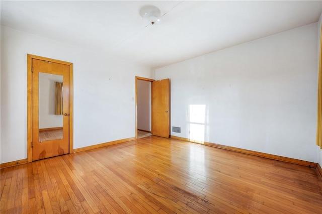 spare room with light hardwood / wood-style flooring