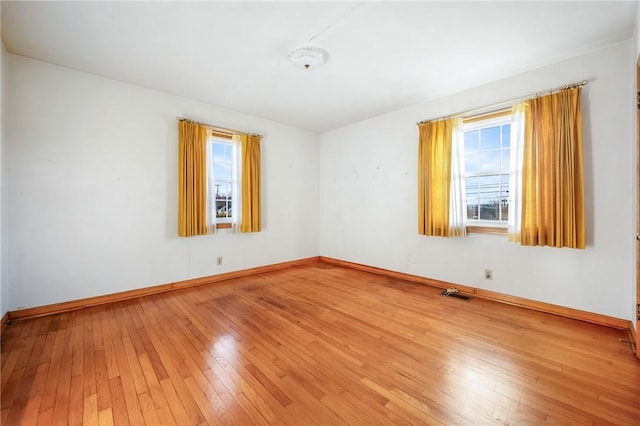 empty room featuring hardwood / wood-style flooring and plenty of natural light