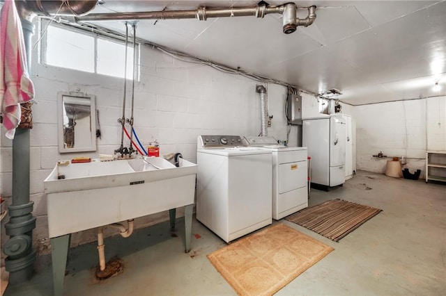 clothes washing area featuring electric panel, sink, and washer and dryer