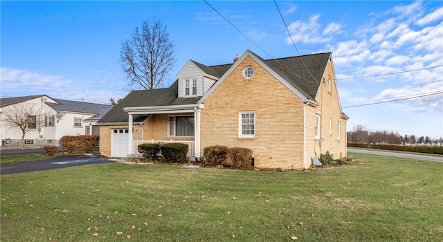 view of front of property featuring a garage and a front lawn