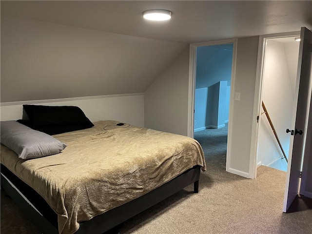 bedroom with carpet flooring and lofted ceiling