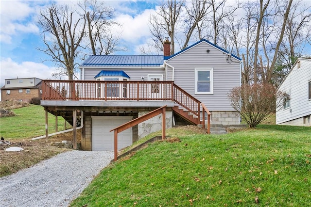 back of house with a yard, a garage, and a deck