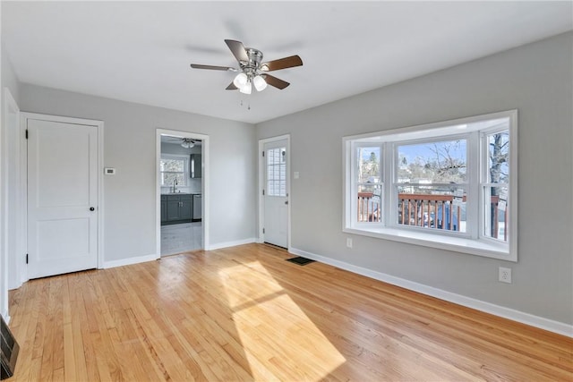 interior space with ceiling fan, light hardwood / wood-style floors, and sink