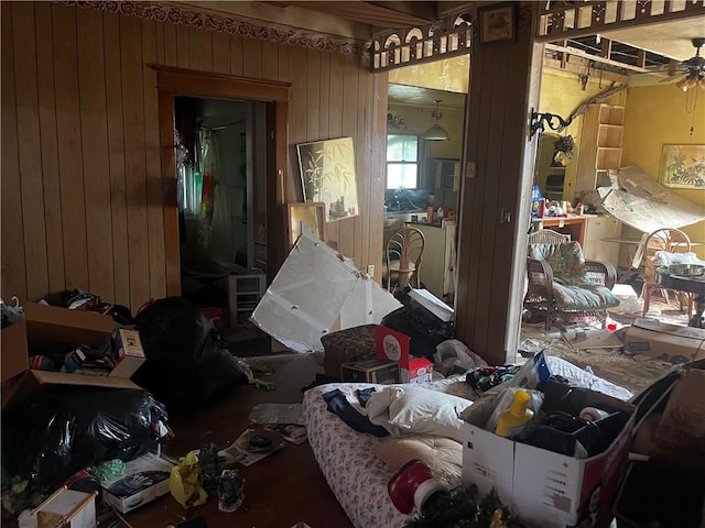 miscellaneous room featuring ceiling fan and wood walls