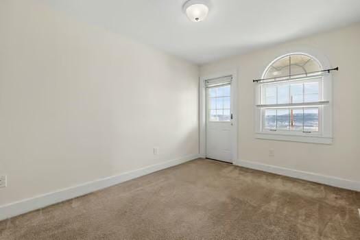 unfurnished room featuring carpet