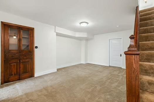 basement featuring light carpet