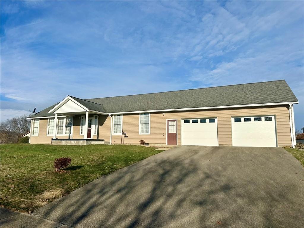 single story home with a front yard, a porch, and a garage