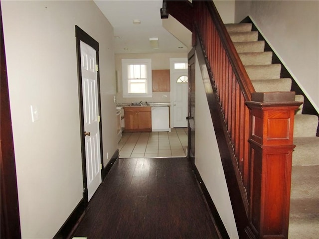 corridor with sink and light hardwood / wood-style floors