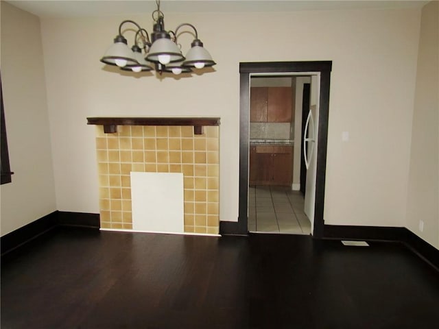 unfurnished dining area featuring light hardwood / wood-style floors and a chandelier