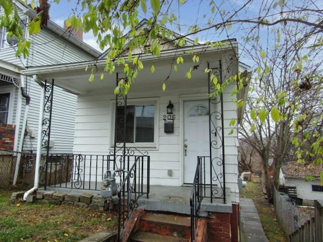 view of exterior entry with covered porch