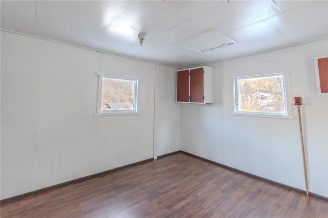 empty room with hardwood / wood-style flooring and a healthy amount of sunlight