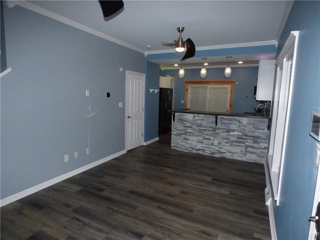 kitchen with crown molding, white cabinets, dark hardwood / wood-style floors, and ceiling fan