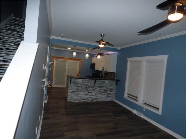 living room featuring ceiling fan, dark hardwood / wood-style flooring, and ornamental molding