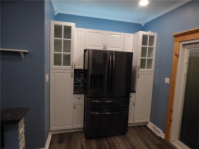 kitchen featuring stainless steel fridge, dark hardwood / wood-style flooring, white cabinetry, and ornamental molding