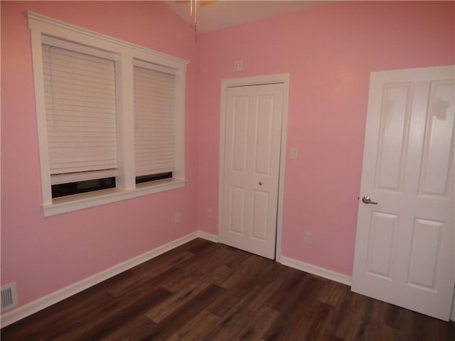 unfurnished bedroom with dark hardwood / wood-style floors