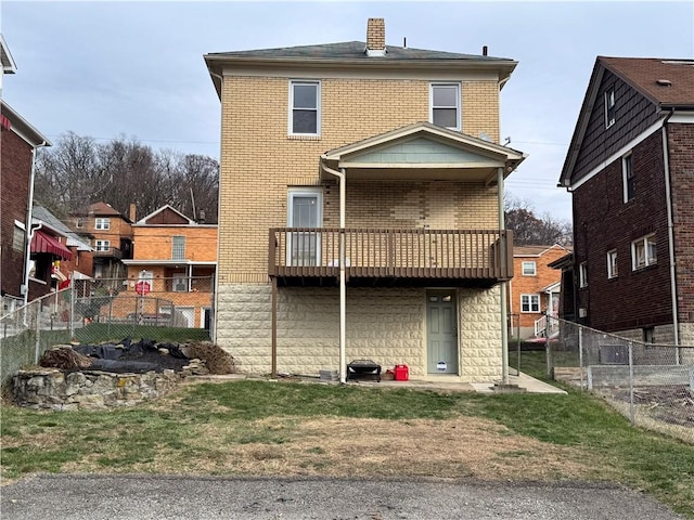 back of house featuring a balcony