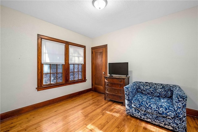 sitting room with hardwood / wood-style flooring